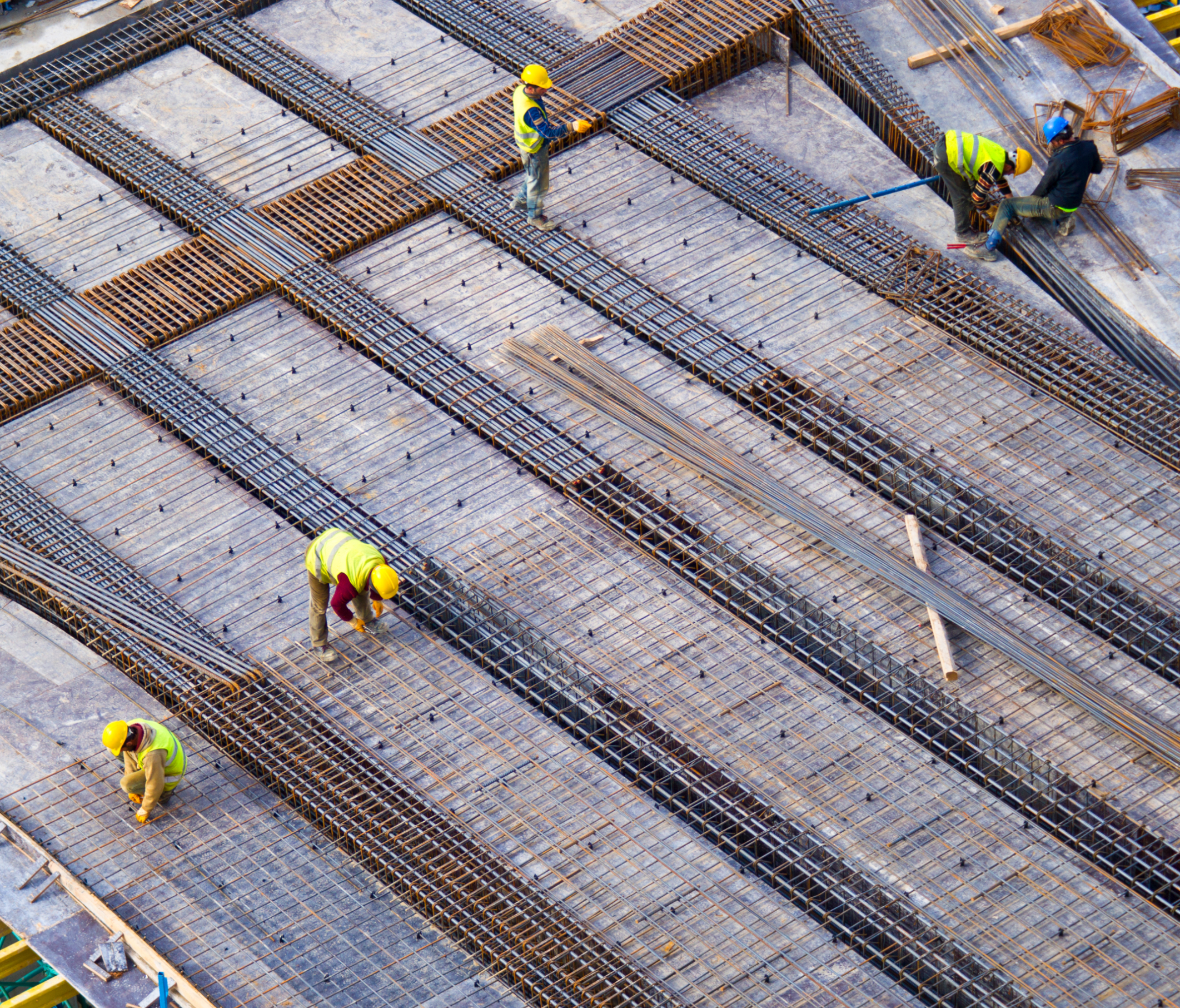 Construction workers laying steel